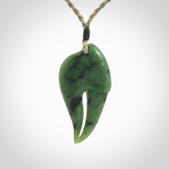 This large crab claw pendant is carved from a lovely deep green piece of New Zealand jade. It has an adjustable Khaki coloured cord which can be slipped over the head and adjusted to the length that you prefer. Hand carved in New Zealand from our local jade by Kyohei Noguchi.