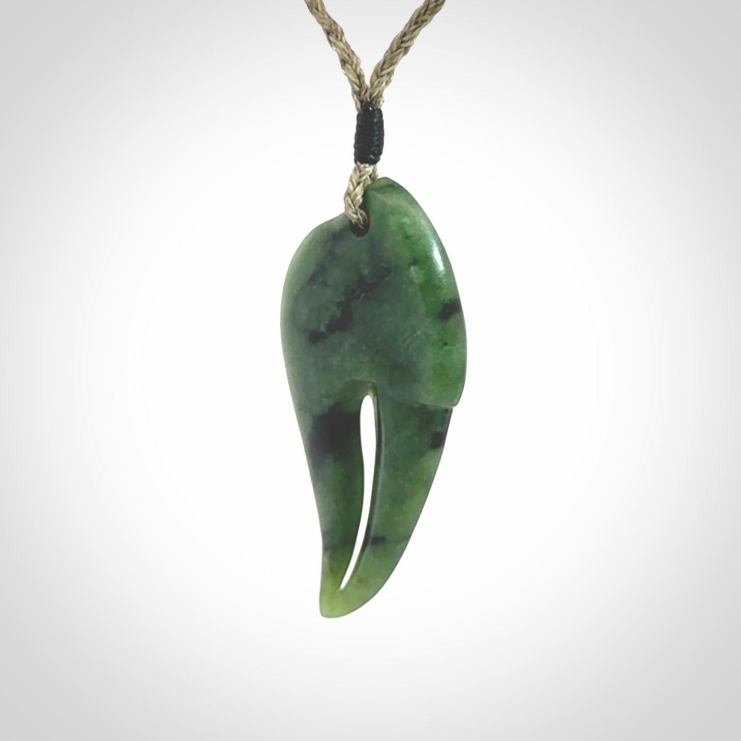 This large crab claw pendant is carved from a lovely deep green piece of New Zealand jade. It has an adjustable Khaki coloured cord which can be slipped over the head and adjusted to the length that you prefer. Hand carved in New Zealand from our local jade by Kyohei Noguchi.