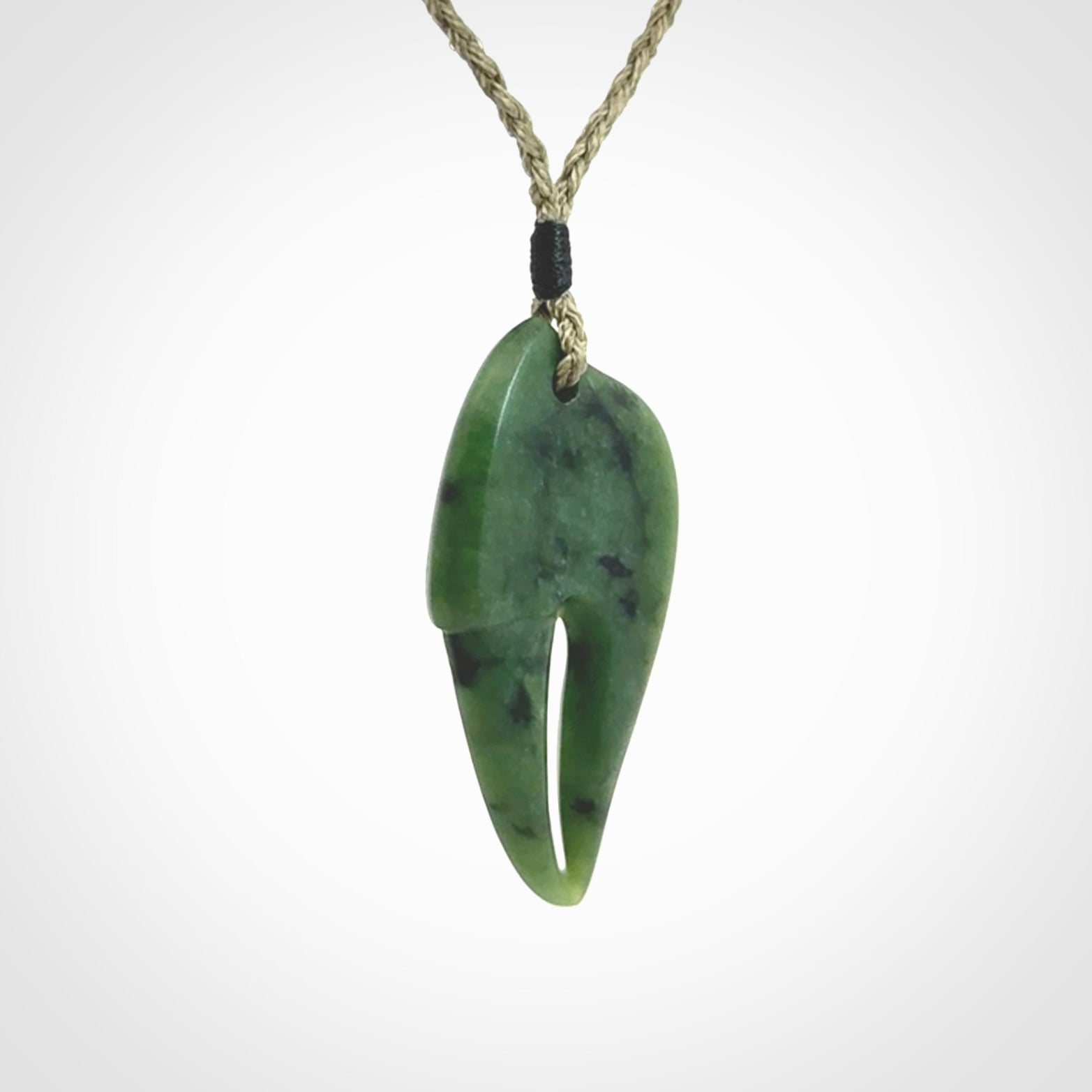 This large crab claw pendant is carved from a lovely deep green piece of New Zealand jade. It has an adjustable Khaki coloured cord which can be slipped over the head and adjusted to the length that you prefer. Hand carved in New Zealand from our local jade by Kyohei Noguchi.