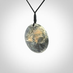 This cupped disc pendant, is carved from a very striking New Zealand Nelson jade.