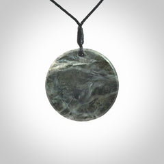 This cupped disc pendant, is carved from a very striking New Zealand Nelson jade.