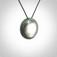 This pendant is a medium sized double koru necklace carved from a New Zealand Jade with Mother of Pearl inlay. Kyohei Noguchi carved this piece for us so the workmanship is outstanding. Handmade in New Zealand, a beautiful piece of jade jewellery.