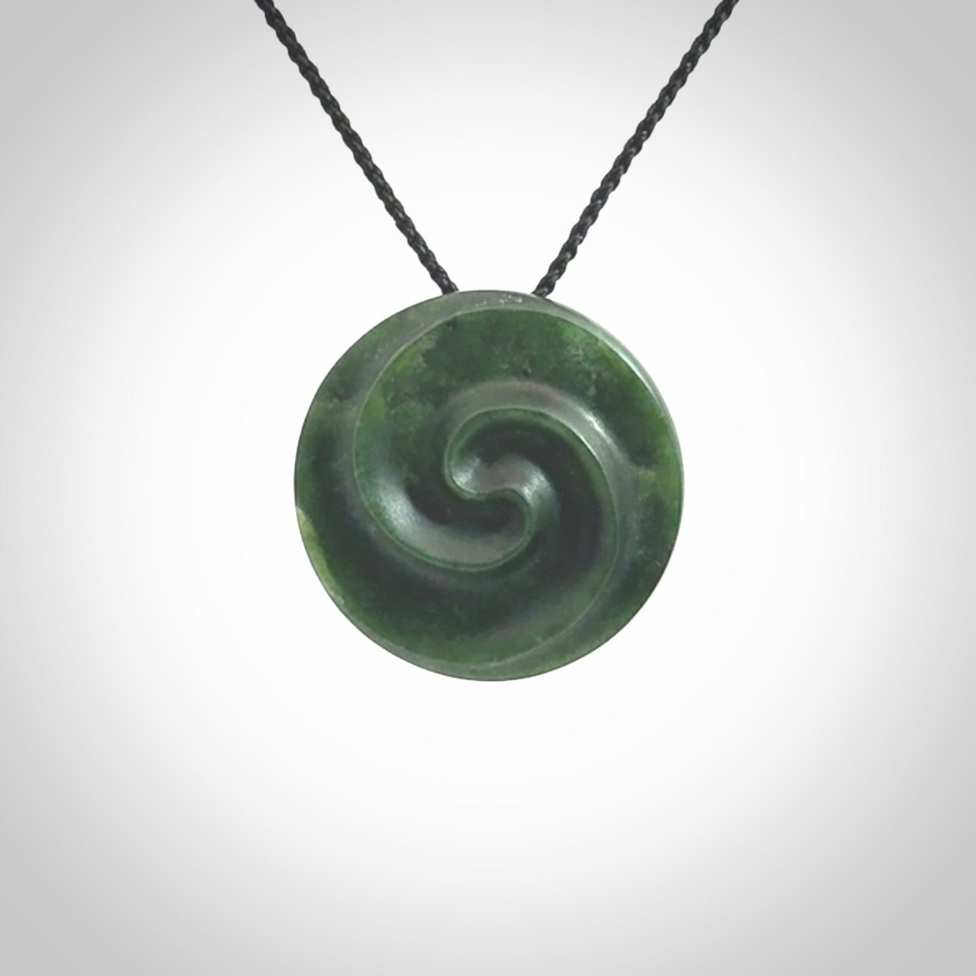 This pendant is a medium sized double koru necklace carved from a New Zealand Jade with Mother of Pearl inlay. Kyohei Noguchi carved this piece for us so the workmanship is outstanding. Handmade in New Zealand, a beautiful piece of jade jewellery.