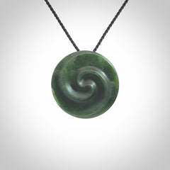 This pendant is a medium sized double koru necklace carved from a New Zealand Jade with Mother of Pearl inlay. Kyohei Noguchi carved this piece for us so the workmanship is outstanding. Handmade in New Zealand, a beautiful piece of jade jewellery.
