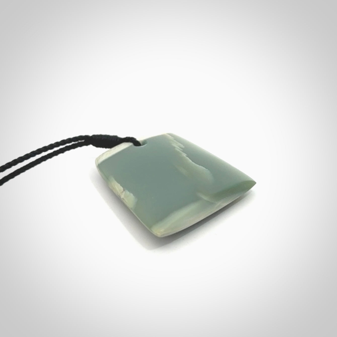 This is a lovely New Zealand Inanga Jade, pounamu Toki drop pendant. Hand carved for us by Kyohei Noguchi. It is bound with an adjustable black coloured cord which is length adjustable. Free worldwide shipping.