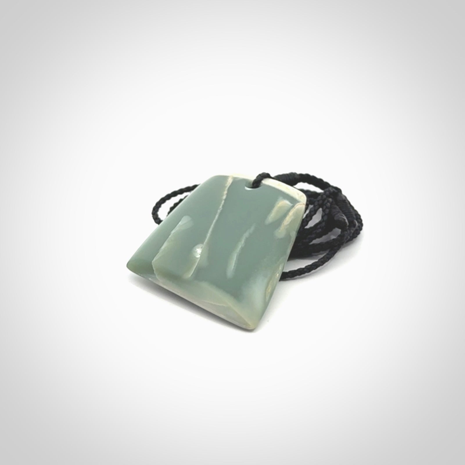 This is a lovely New Zealand Inanga Jade, pounamu Toki drop pendant. Hand carved for us by Kyohei Noguchi. It is bound with an adjustable black coloured cord which is length adjustable. Free worldwide shipping.