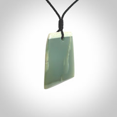 This is a lovely New Zealand Inanga Jade, pounamu Toki drop pendant. Hand carved for us by Kyohei Noguchi. It is bound with an adjustable black coloured cord which is length adjustable. Free worldwide shipping.