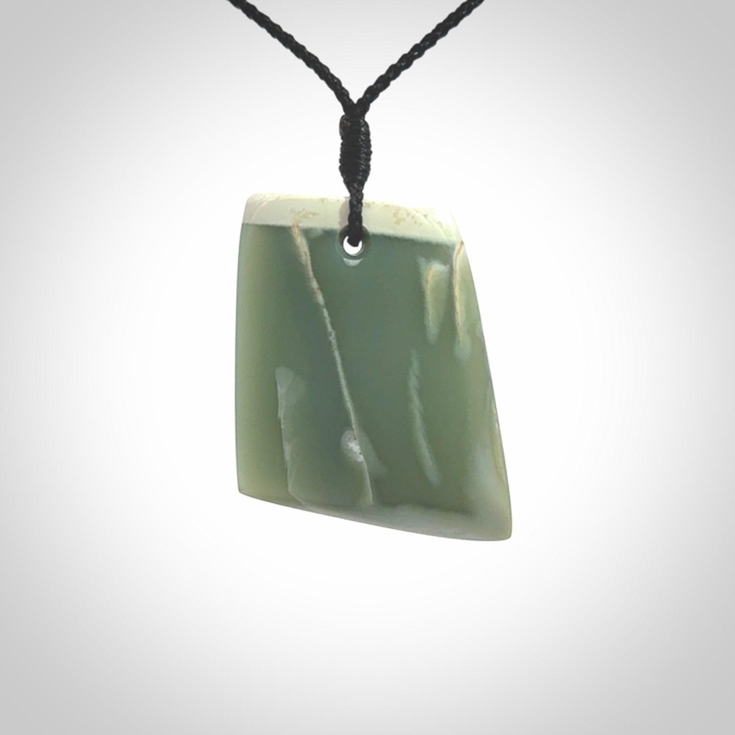 This is a lovely New Zealand Inanga Jade, pounamu Toki drop pendant. Hand carved for us by Kyohei Noguchi. It is bound with an adjustable black coloured cord which is length adjustable. Free worldwide shipping.
