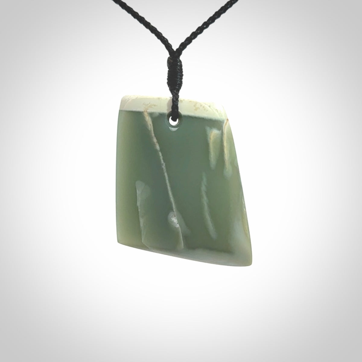 This is a lovely New Zealand Inanga Jade, pounamu Toki drop pendant. Hand carved for us by Kyohei Noguchi. It is bound with an adjustable black coloured cord which is length adjustable. Free worldwide shipping.