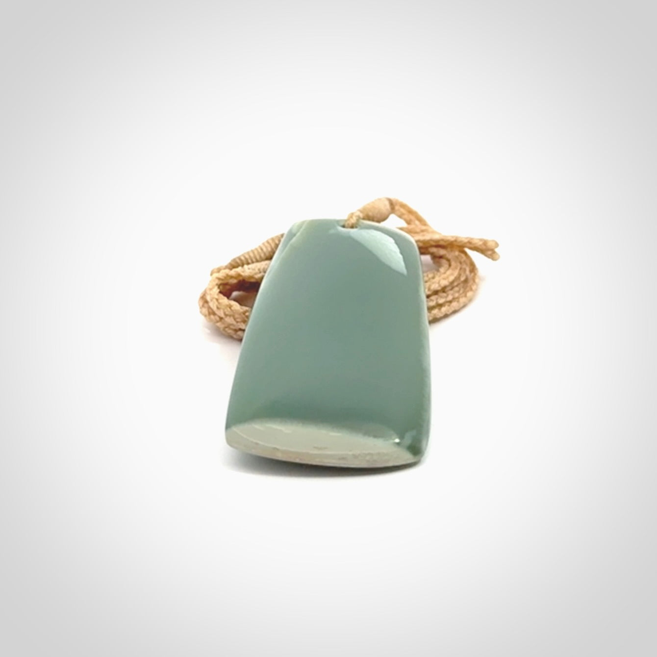 This is a lovely New Zealand Inanga Jade, pounamu Toki drop pendant. Hand carved for us by Kyohei Noguchi. It is bound with an adjustable beige coloured cord which is length adjustable. Free worldwide shipping.