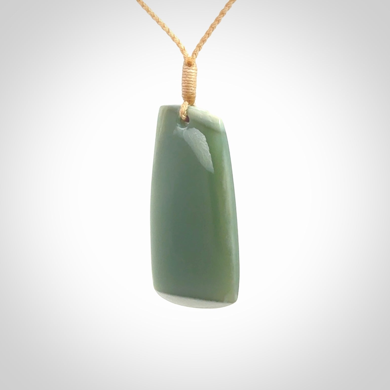 This is a lovely New Zealand Inanga Jade, pounamu Toki drop pendant. Hand carved for us by Kyohei Noguchi. It is bound with an adjustable beige coloured cord which is length adjustable. Free worldwide shipping.
