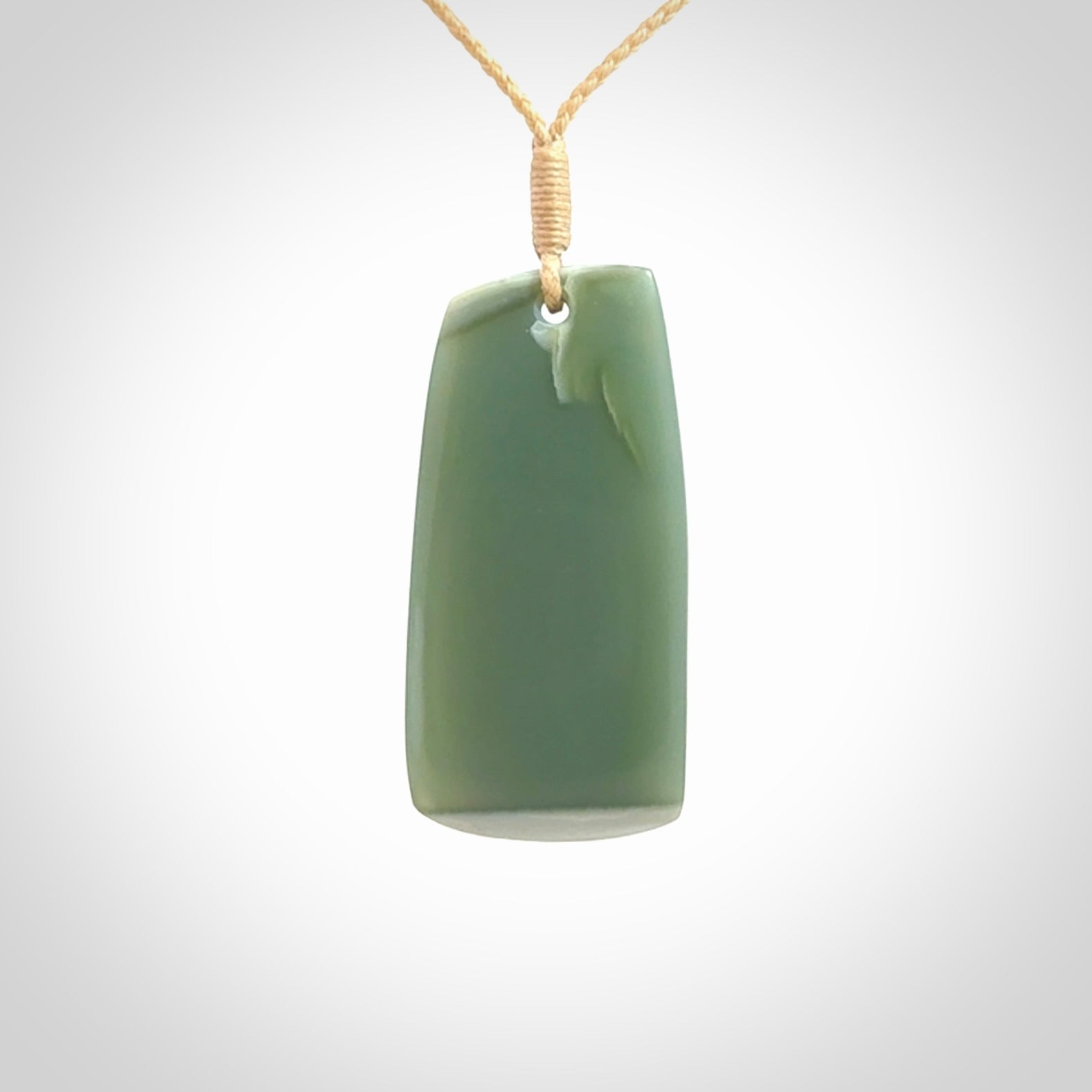 This is a lovely New Zealand Inanga Jade, pounamu Toki drop pendant. Hand carved for us by Kyohei Noguchi. It is bound with an adjustable beige coloured cord which is length adjustable. Free worldwide shipping.