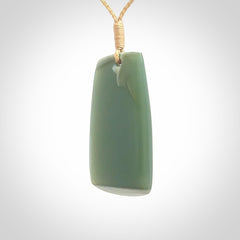 This is a lovely New Zealand Inanga Jade, pounamu Toki drop pendant. Hand carved for us by Kyohei Noguchi. It is bound with an adjustable beige coloured cord which is length adjustable. Free worldwide shipping.