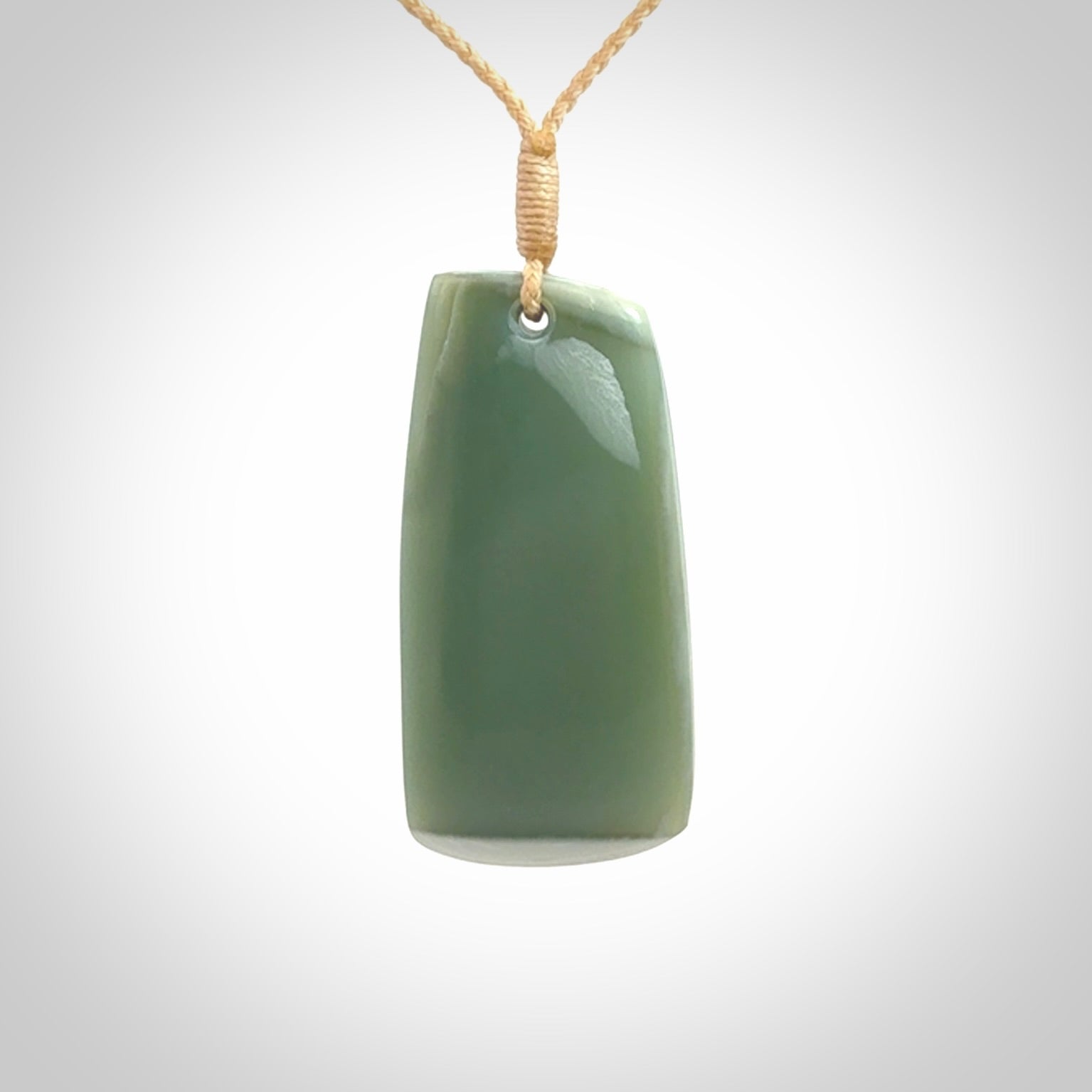 This is a lovely New Zealand Inanga Jade, pounamu Toki drop pendant. Hand carved for us by Kyohei Noguchi. It is bound with an adjustable beige coloured cord which is length adjustable. Free worldwide shipping.