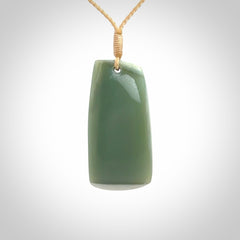 This is a lovely New Zealand Inanga Jade, pounamu Toki drop pendant. Hand carved for us by Kyohei Noguchi. It is bound with an adjustable beige coloured cord which is length adjustable. Free worldwide shipping.