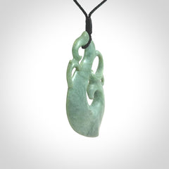 This picture shows a contemporary manaia with hook pendant carved for us by Kyohei Noguchi. It is a light green colour in traditional manaia design. We have plaited a cord in black and made it length adjustable. This is a very beautiful piece of art to wear.