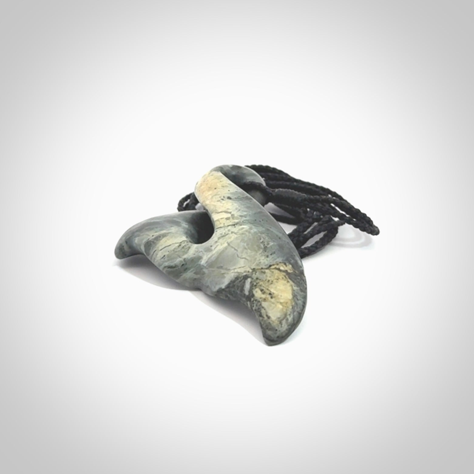This whale tail twist pendant, is carved from a very striking New Zealand Nelson jade.
