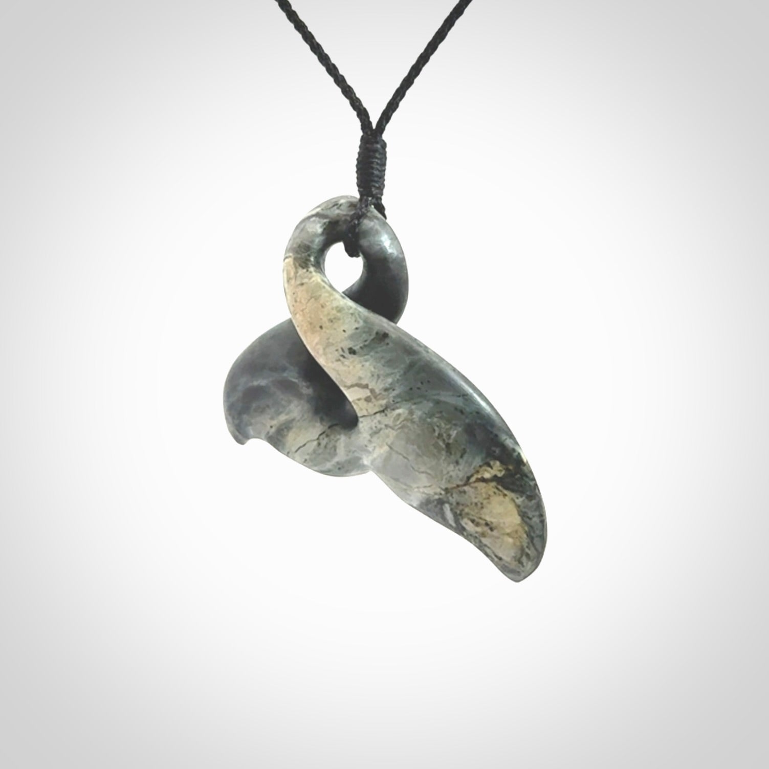 This whale tail twist pendant, is carved from a very striking New Zealand Nelson jade.