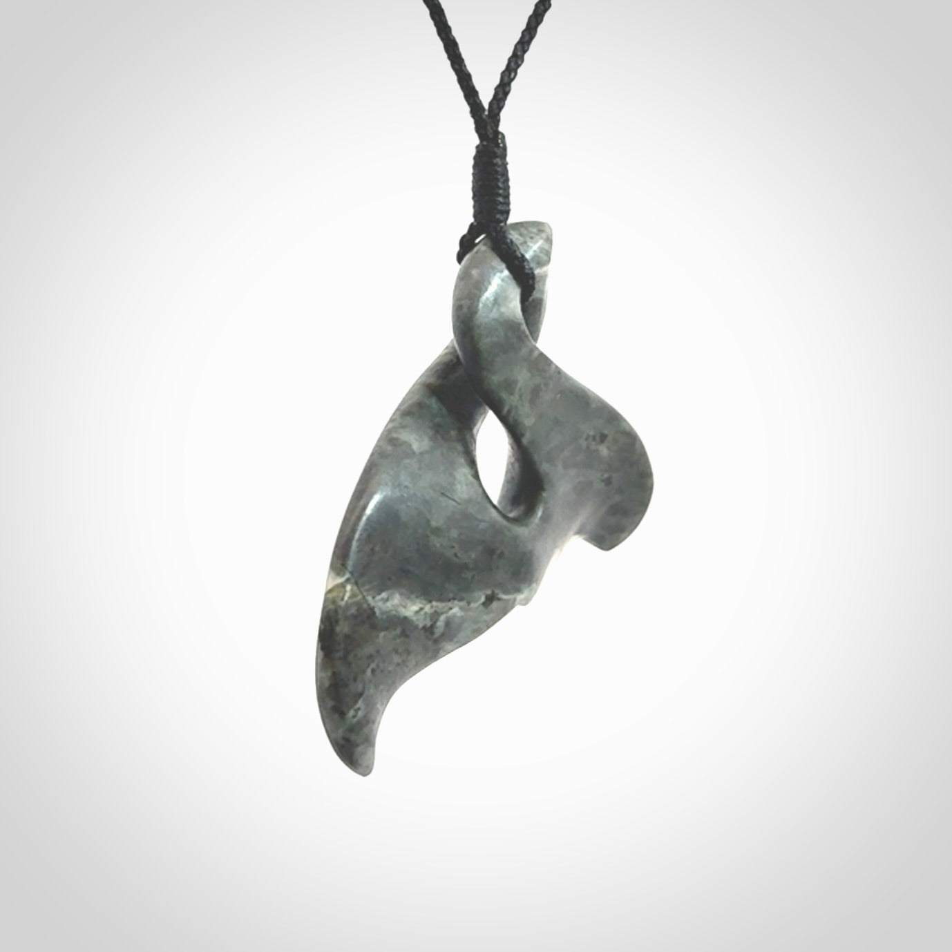 This whale tail twist pendant, is carved from a very striking New Zealand Nelson jade.