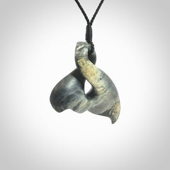 This whale tail twist pendant, is carved from a very striking New Zealand Nelson jade.
