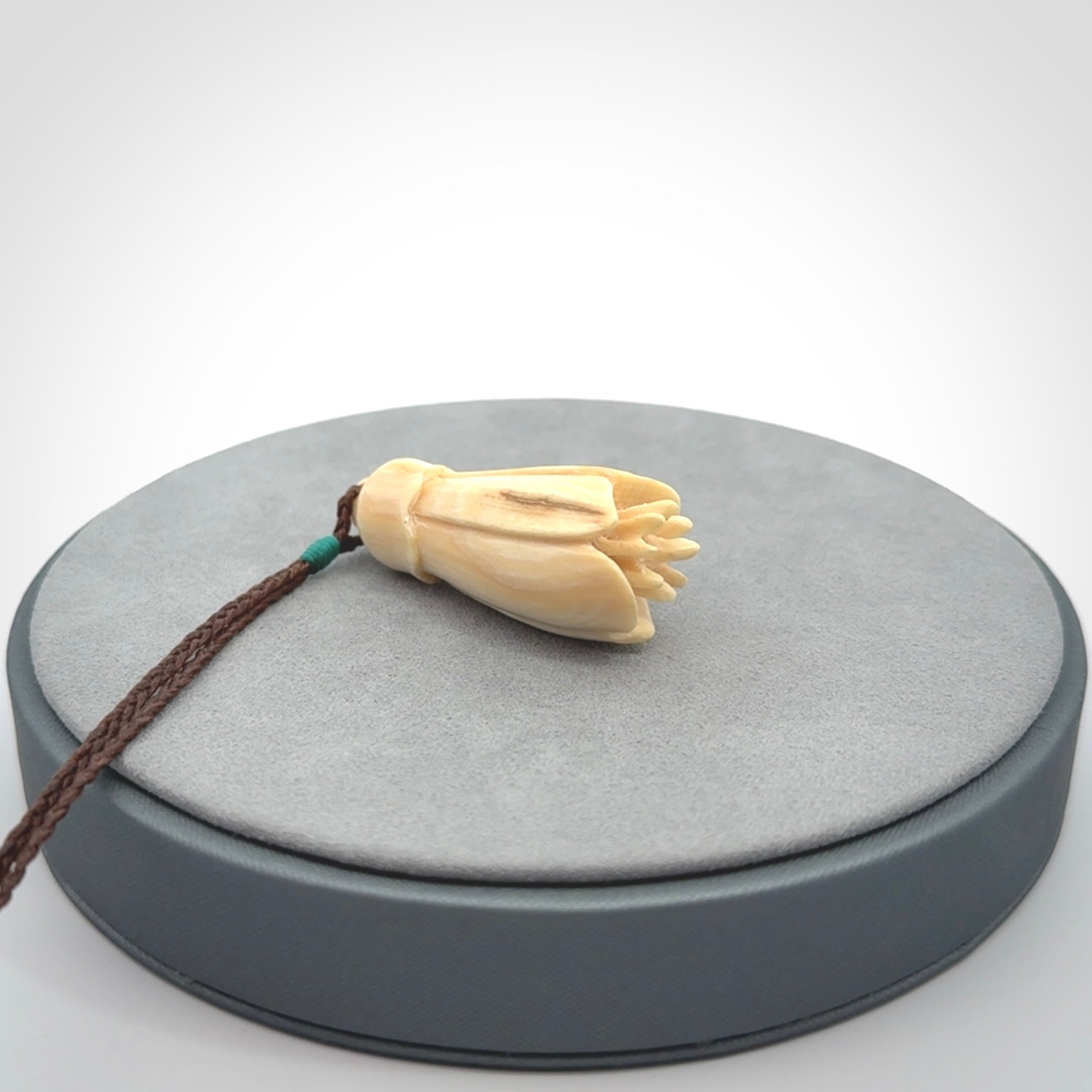 Hand carved Kowhai flower. These are made from Woolly Mammoth tusk and are a soft golden colour. They are provided with a hand plaited, adjustable cord. Shipping is free worldwide.