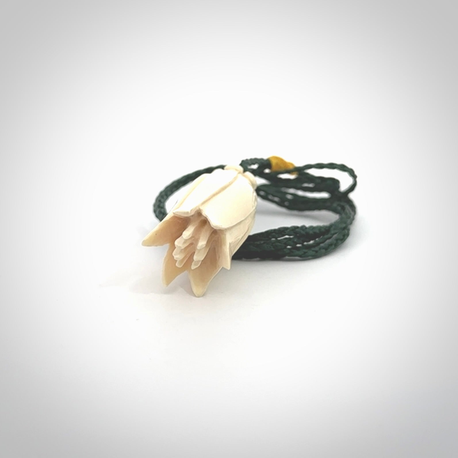 Hand carved Kowhai flower. These are made from Woolly Mammoth tusk and are a soft golden brown colour. They are provided with a hand plaited, adjustable cord. Shipping is free worldwide.