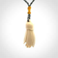 Hand carved Kowhai flower. These are made from Woolly Mammoth tusk and are a soft golden colour. They are provided with a hand plaited, adjustable cord. Shipping is free worldwide.
