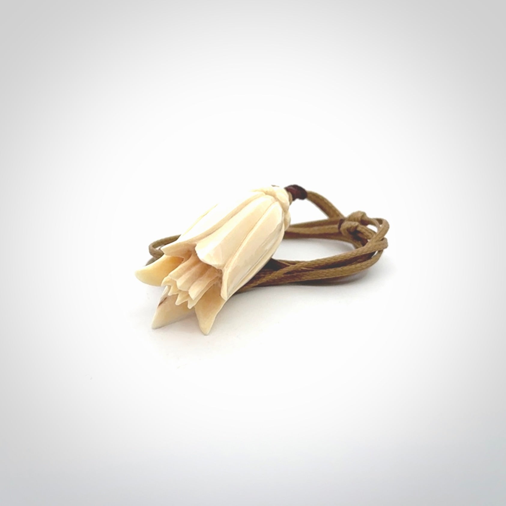 Hand carved Kowhai flower. These are made from Woolly Mammoth tusk and are a soft golden brown colour. They are provided with an adjustable cord. Shipping is free worldwide.