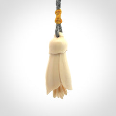 Hand carved Kowhai flower. These are made from Woolly Mammoth tusk and are a soft golden colour. They are provided with a hand plaited, adjustable cord. Shipping is free worldwide.
