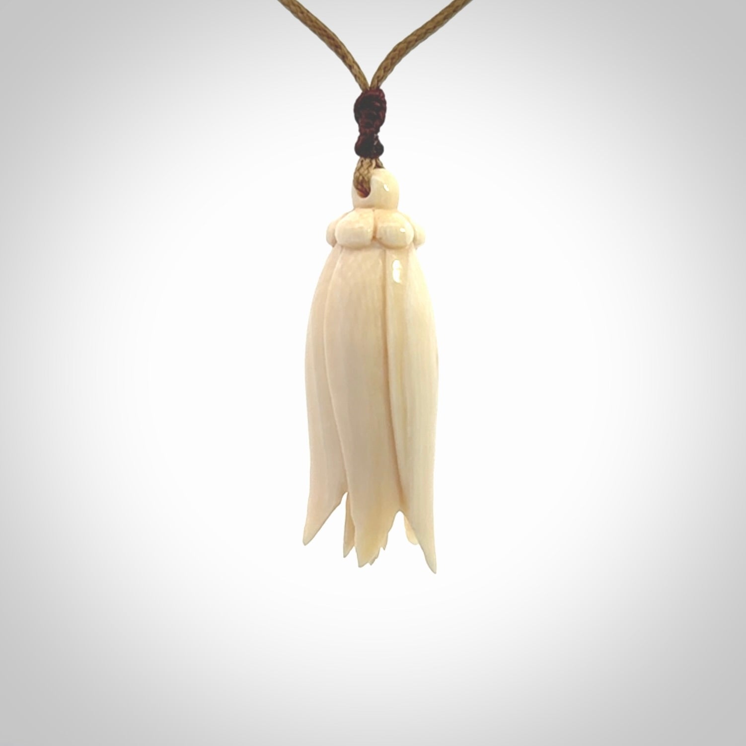 Hand carved Kowhai flower. These are made from Woolly Mammoth tusk and are a soft golden brown colour. They are provided with an adjustable cord. Shipping is free worldwide.