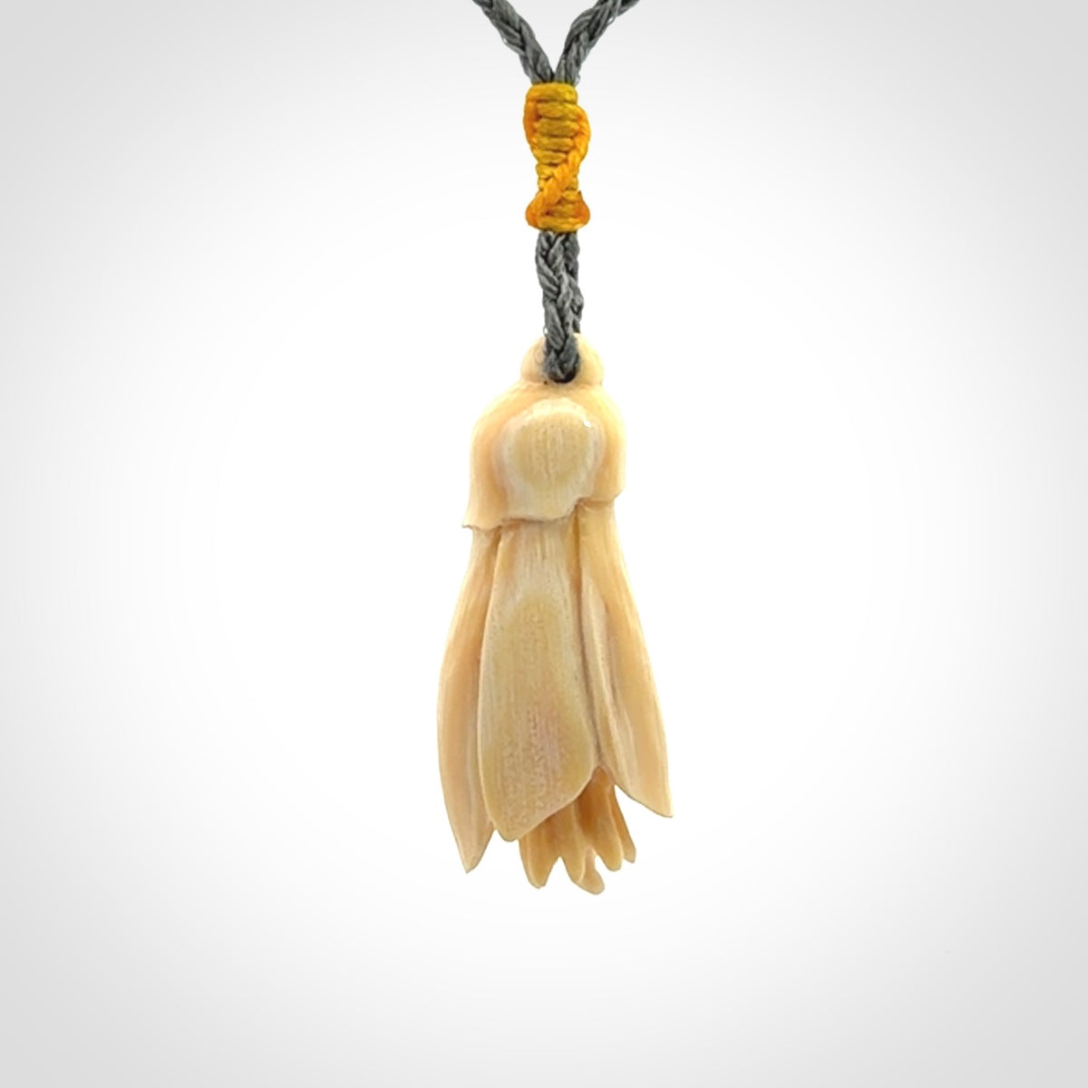 Hand carved Kowhai flower. These are made from Woolly Mammoth tusk and are a soft golden colour. They are provided with a hand plaited, adjustable cord. Shipping is free worldwide.