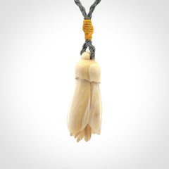 Hand carved Kowhai flower. These are made from Woolly Mammoth tusk and are a soft golden colour. They are provided with a hand plaited, adjustable cord. Shipping is free worldwide.