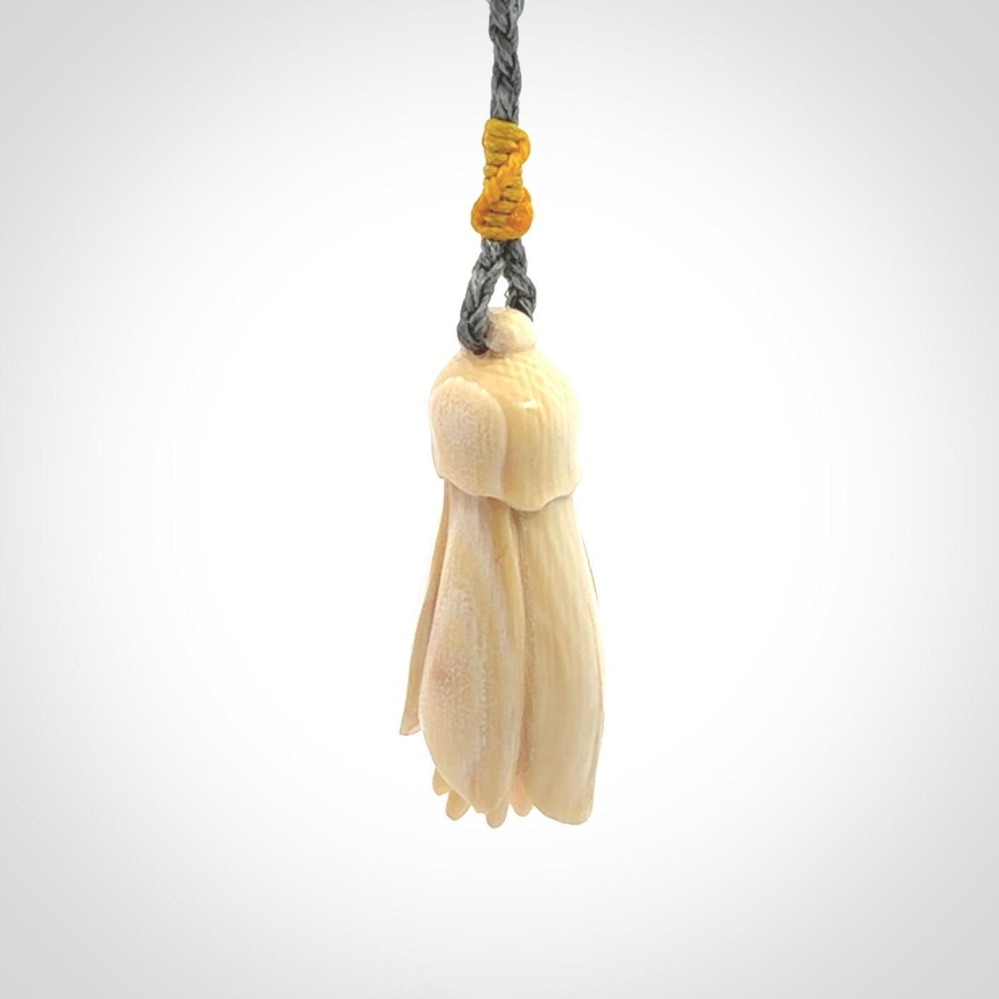 Hand carved Kowhai flower. These are made from Woolly Mammoth tusk and are a soft golden colour. They are provided with a hand plaited, adjustable cord. Shipping is free worldwide.