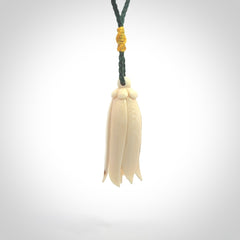 Hand carved Kowhai flower. These are made from Woolly Mammoth tusk and are a soft golden brown colour. They are provided with a hand plaited, adjustable cord. Shipping is free worldwide.