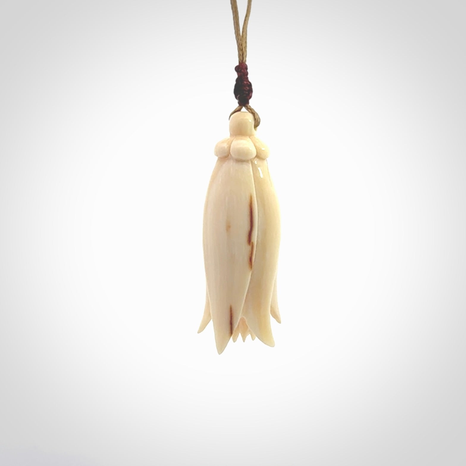 Hand carved Kowhai flower. These are made from Woolly Mammoth tusk and are a soft golden brown colour. They are provided with an adjustable cord. Shipping is free worldwide.