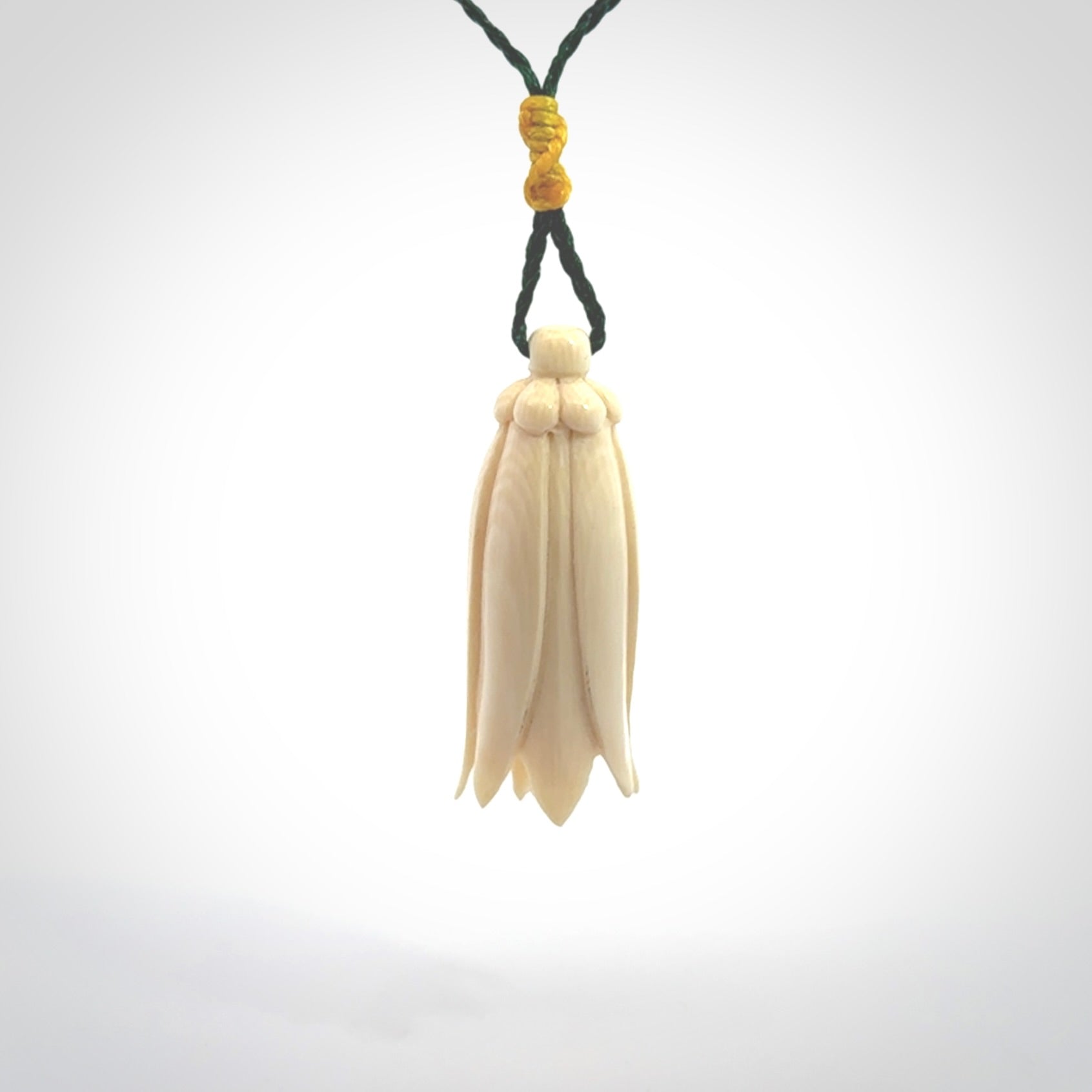 Hand carved Kowhai flower. These are made from Woolly Mammoth tusk and are a soft golden brown colour. They are provided with a hand plaited, adjustable cord. Shipping is free worldwide.