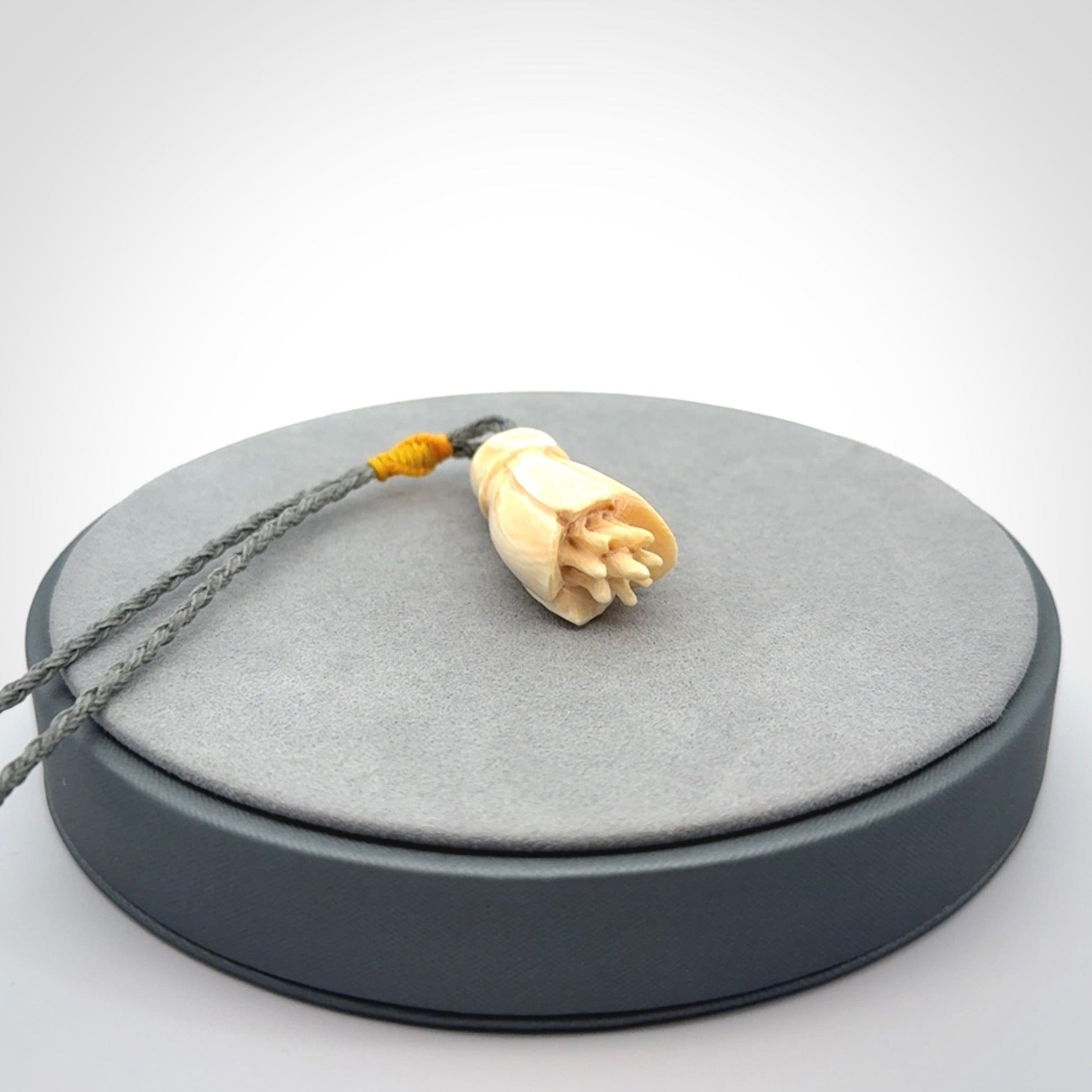 Hand carved Kowhai flower. These are made from Woolly Mammoth tusk and are a soft golden colour. They are provided with a hand plaited, adjustable cord. Shipping is free worldwide.