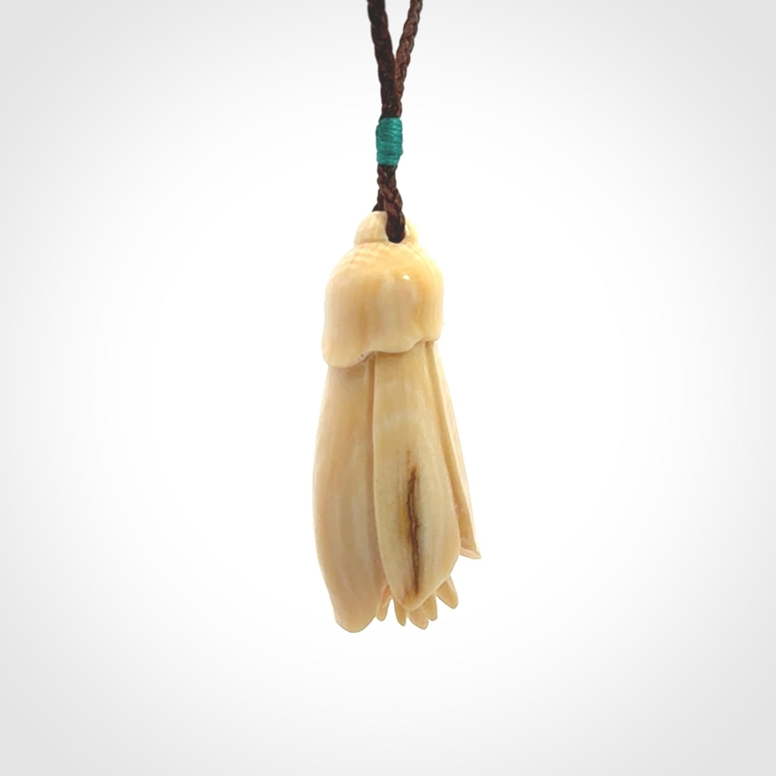 Hand carved Kowhai flower. These are made from Woolly Mammoth tusk and are a soft golden colour. They are provided with a hand plaited, adjustable cord. Shipping is free worldwide.