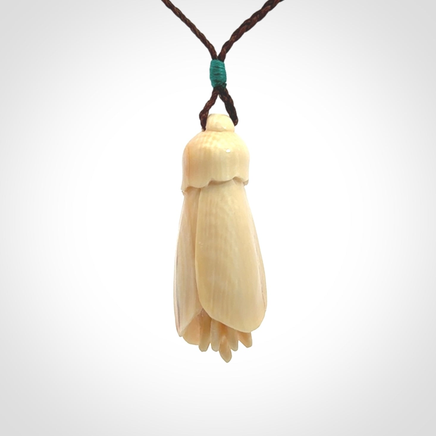 Hand carved Kowhai flower. These are made from Woolly Mammoth tusk and are a soft golden colour. They are provided with a hand plaited, adjustable cord. Shipping is free worldwide.