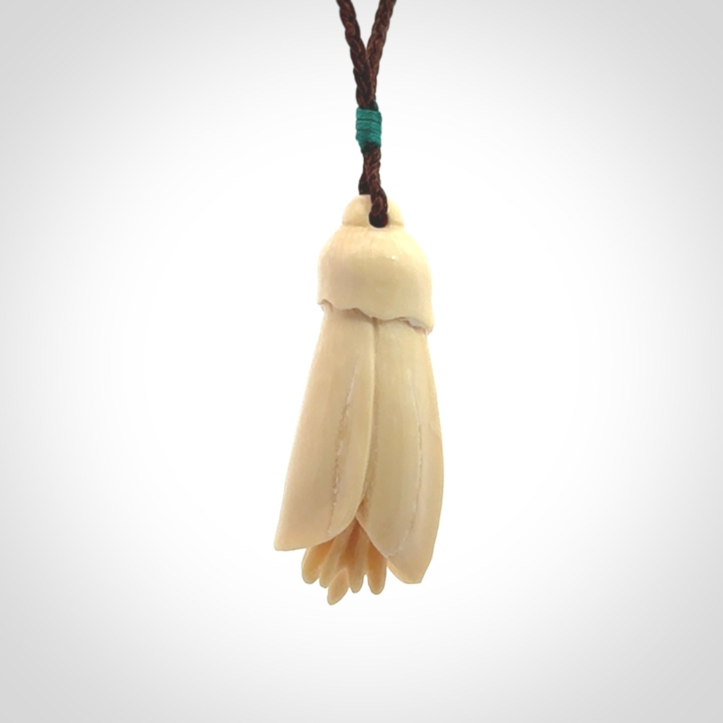 Hand carved Kowhai flower. These are made from Woolly Mammoth tusk and are a soft golden colour. They are provided with a hand plaited, adjustable cord. Shipping is free worldwide.