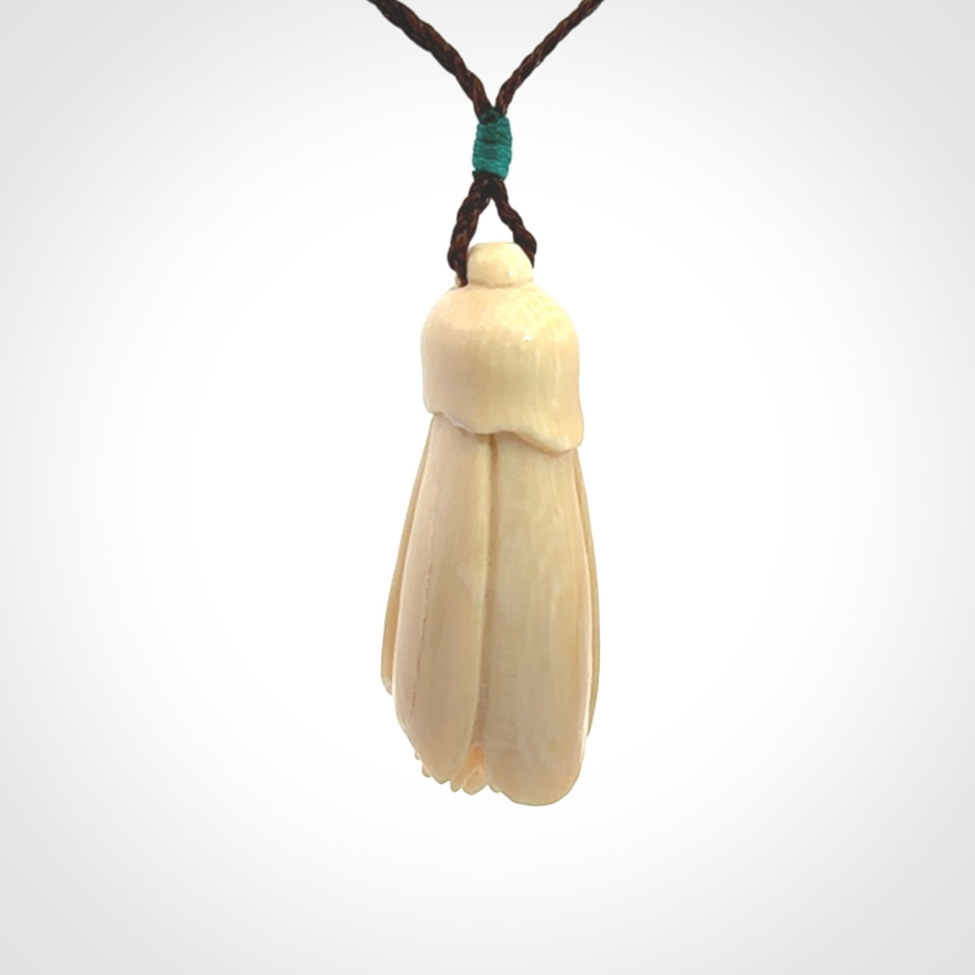 Hand carved Kowhai flower. These are made from Woolly Mammoth tusk and are a soft golden colour. They are provided with a hand plaited, adjustable cord. Shipping is free worldwide.