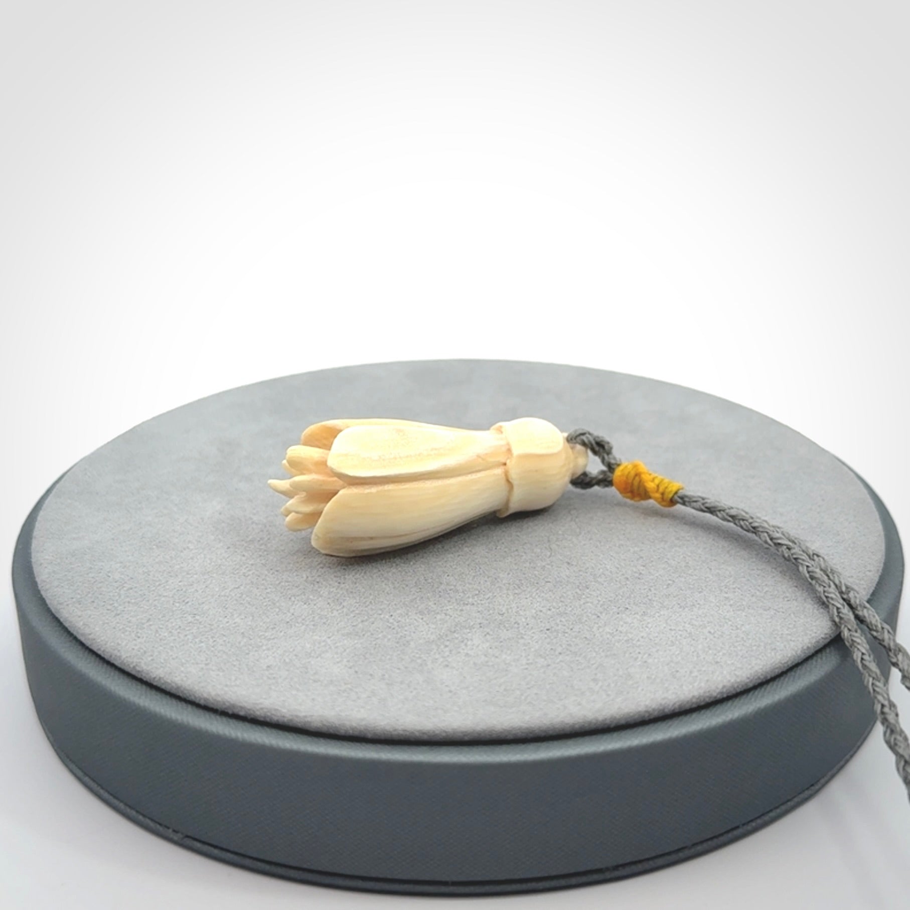 Hand carved Kowhai flower. These are made from Woolly Mammoth tusk and are a soft golden colour. They are provided with a hand plaited, adjustable cord. Shipping is free worldwide.