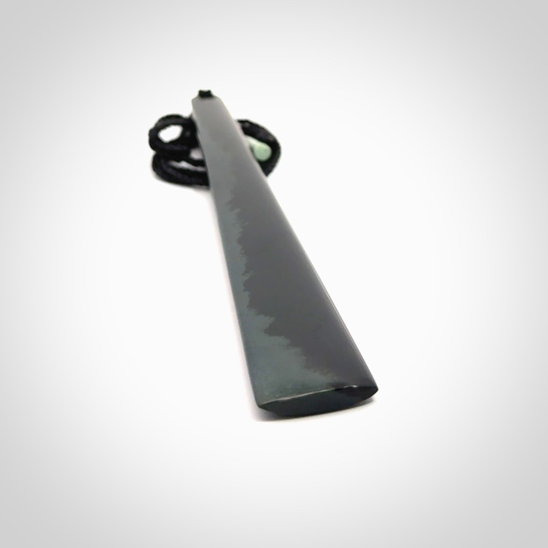 A hand carved large Black Jade drop, roimata, necklace. The cord is a black colour and is a fixed length. A large sized hand made drop necklace by New Zealand artist Kerry Thompson. One off work of art to wear.