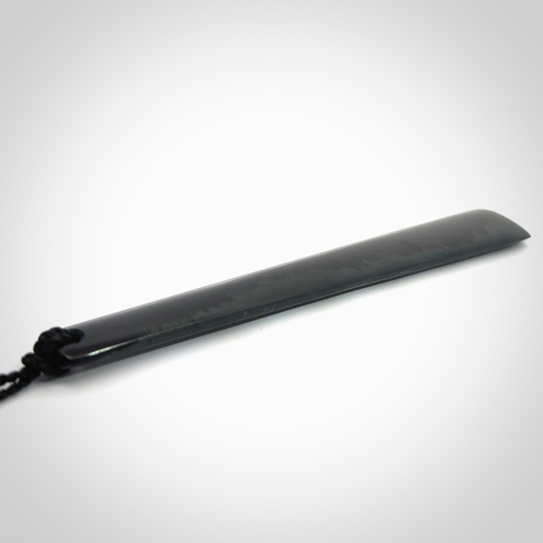 A hand carved large Black Jade drop, roimata, necklace. The cord is a black colour and is a fixed length. A large sized hand made drop necklace by New Zealand artist Kerry Thompson. One off work of art to wear.