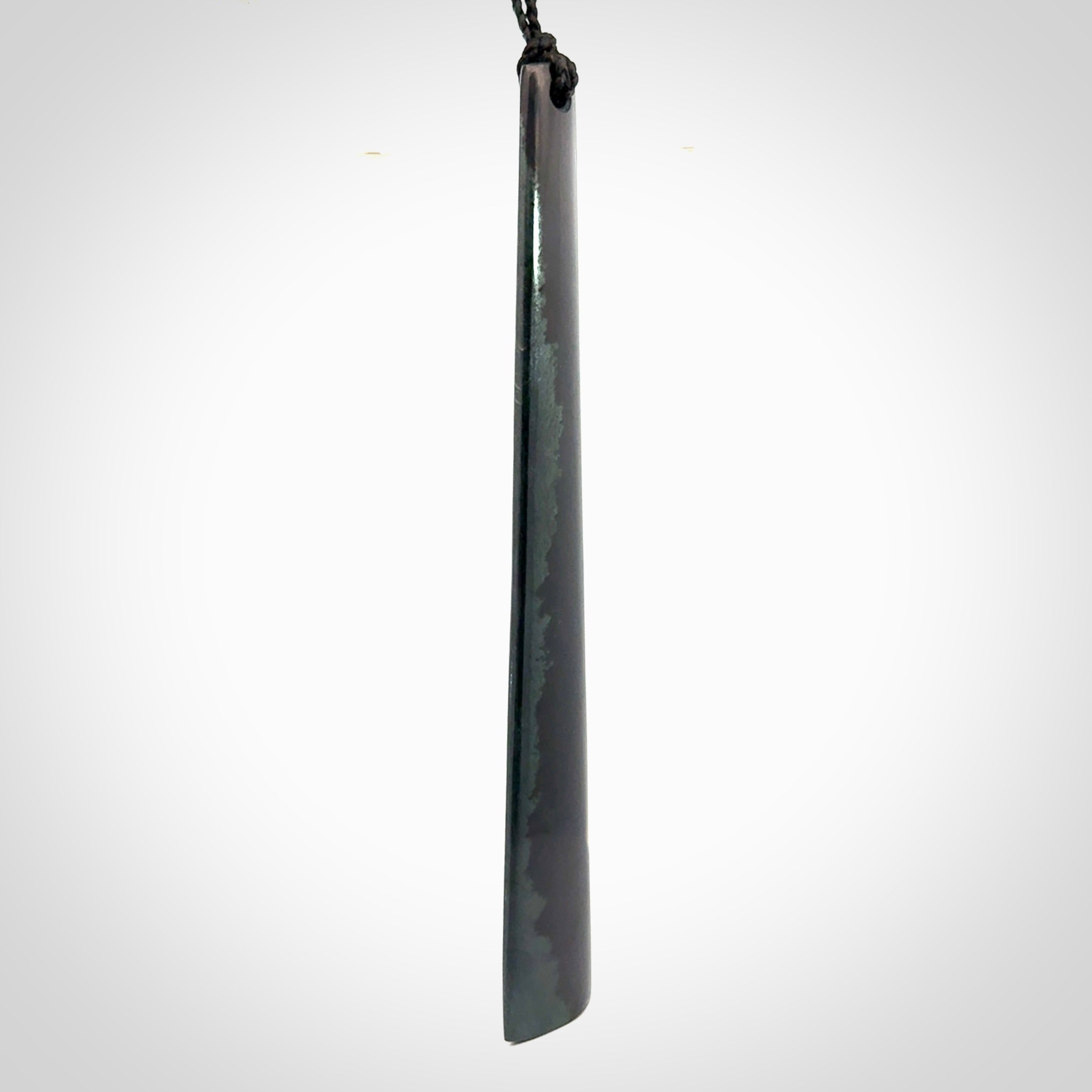 A hand carved large Black Jade drop, roimata, necklace. The cord is a black colour and is a fixed length. A large sized hand made drop necklace by New Zealand artist Kerry Thompson. One off work of art to wear.