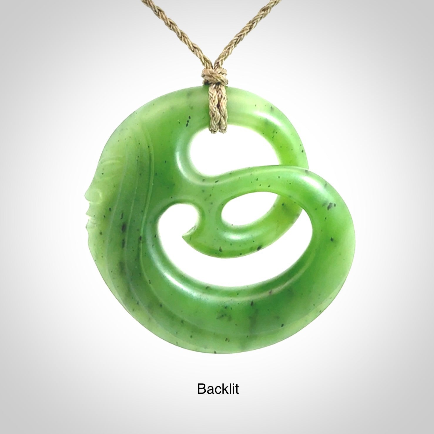 A hand carved complex face pendant from Siberian Jade. The cord is 4-plait khaki and is adjustable.
