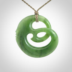 A hand carved complex face pendant from Siberian Jade. The cord is 4-plait khaki and is adjustable.