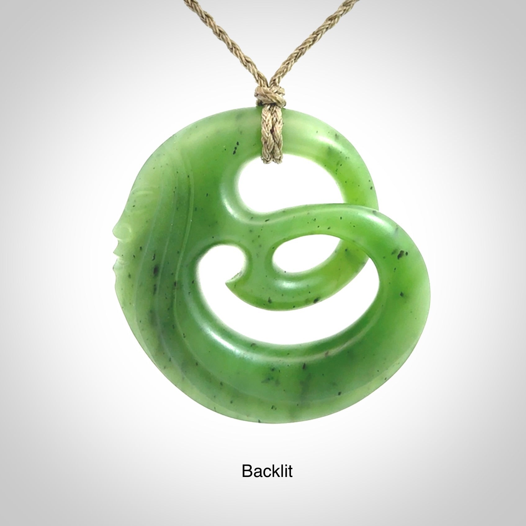 A hand carved complex face pendant from Siberian Jade. The cord is 4-plait khaki and is adjustable.