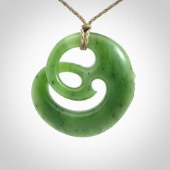 A hand carved complex face pendant from Siberian Jade. The cord is 4-plait khaki and is adjustable.