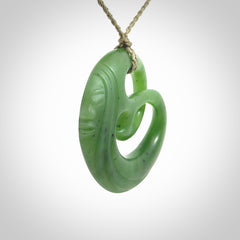 A hand carved complex face pendant from Siberian Jade. The cord is 4-plait khaki and is adjustable.